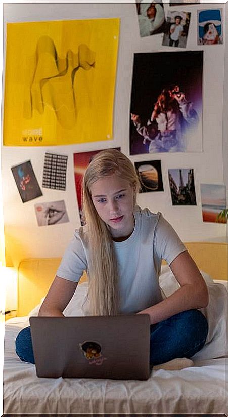 Teenage girl in bed with her laptop