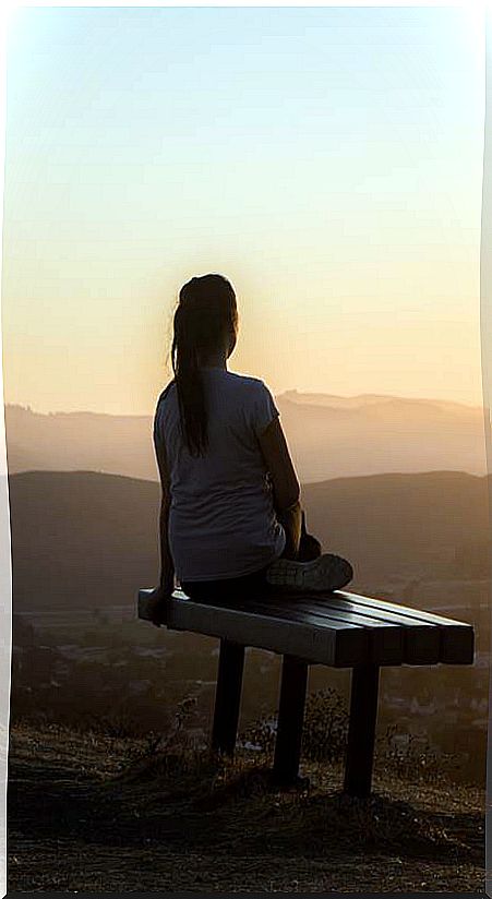 Woman contemplating the sunrise